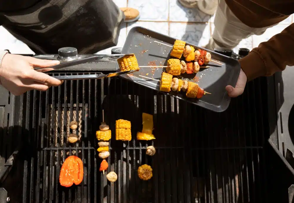Grilling veggie skewers on a charcoal barbecue.
