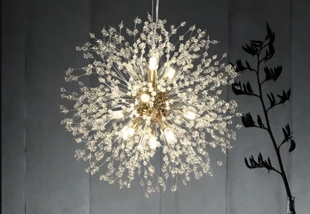 Gold starburst chandelier with crystal lights.