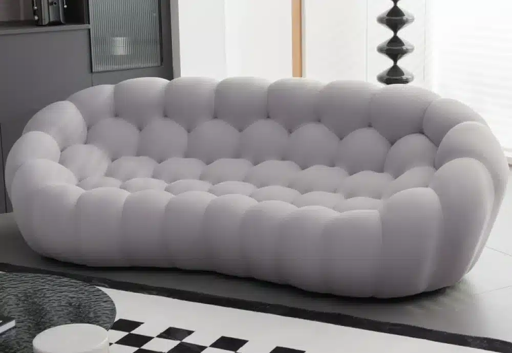 Grey bubble-style sofa in a modern black-and-white room.