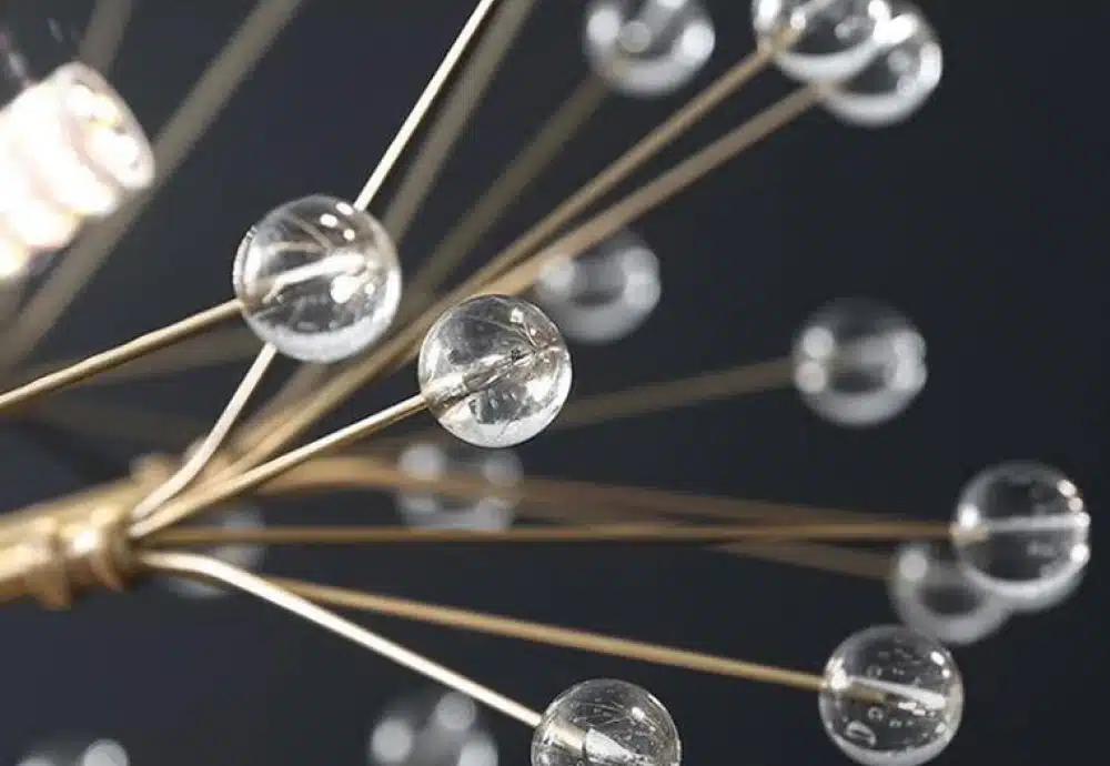 Close-up of glass orbs on golden rods in a starburst pattern.