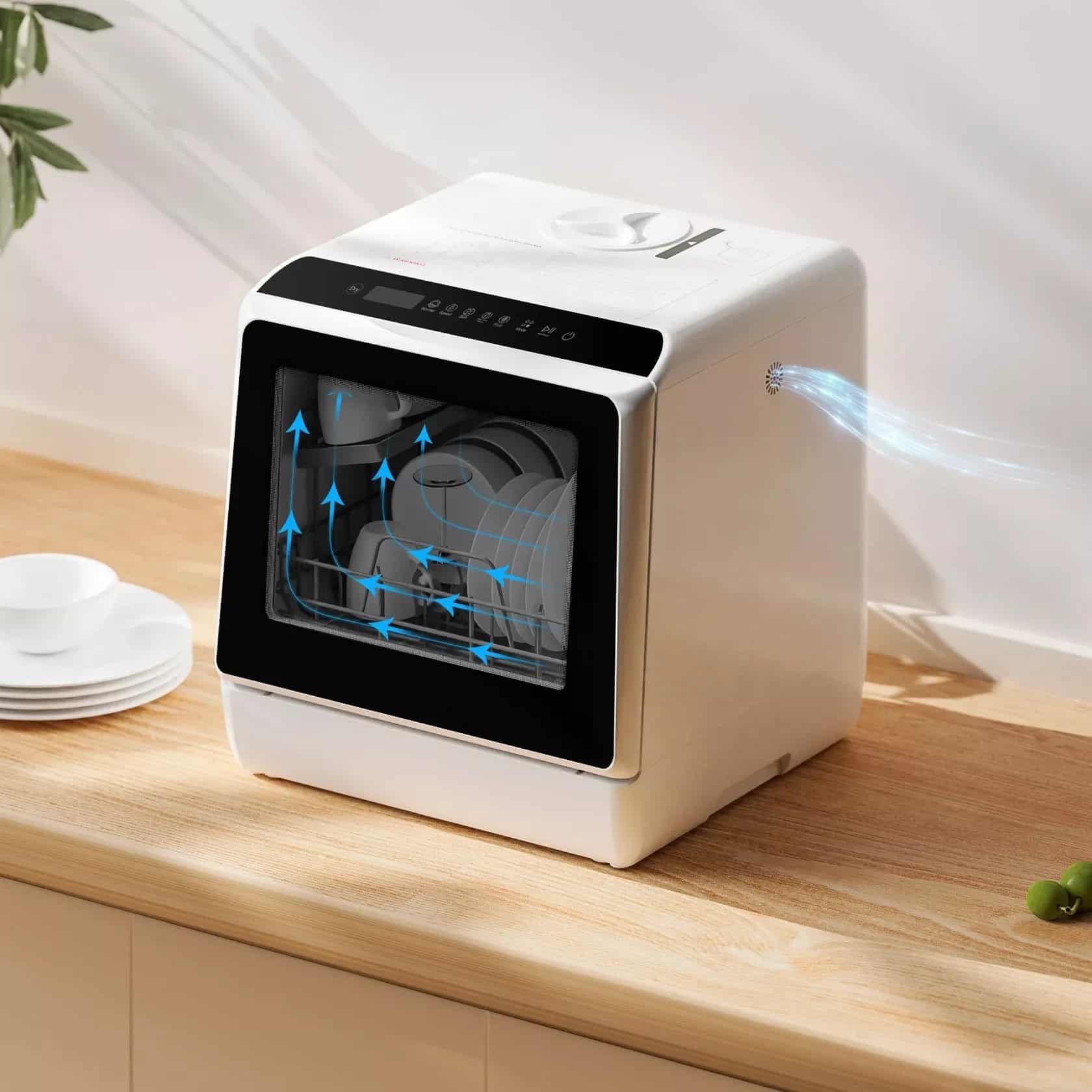 White countertop dishwasher with built-in water tank and digital controls showing airflow pattern on wooden counter